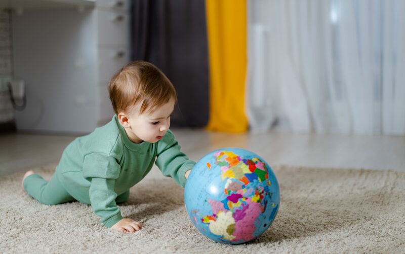 A child is looking at a globe.
