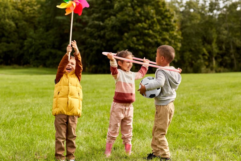 Three children play outside.