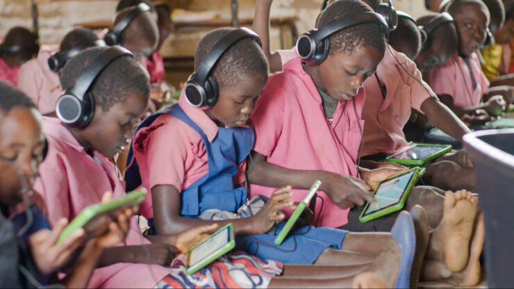 Children learn on tablets.