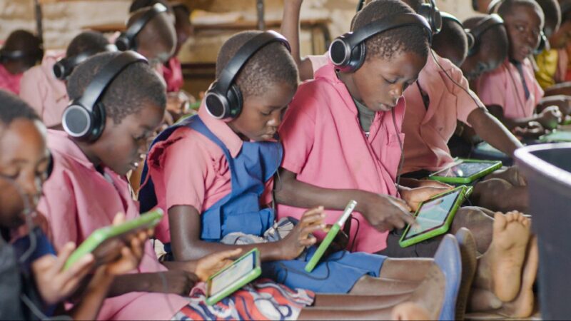 Children learn on tablets.