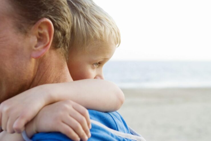 A young child is comforted by a caregiver.