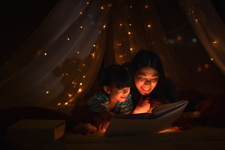 A mother and daughter read a bedtime story together.