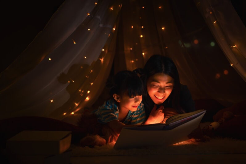 A mother and daughter read a bedtime story together.
