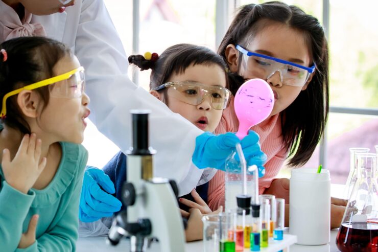 Young students observe a science experiment in class.