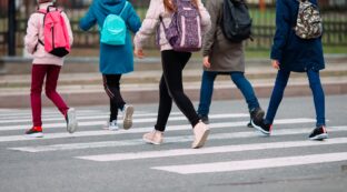 A group of children are crossing a crosswalk.