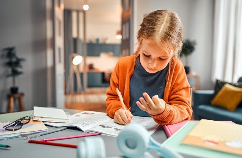A child learning math uses her fingers to count.