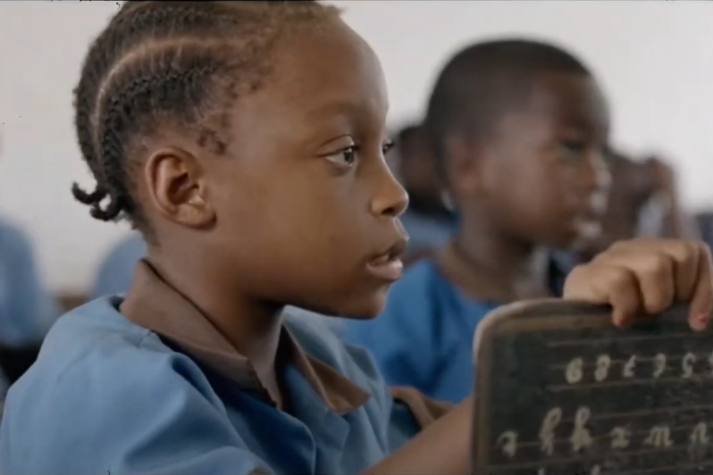 A child learns using a chalkboard.